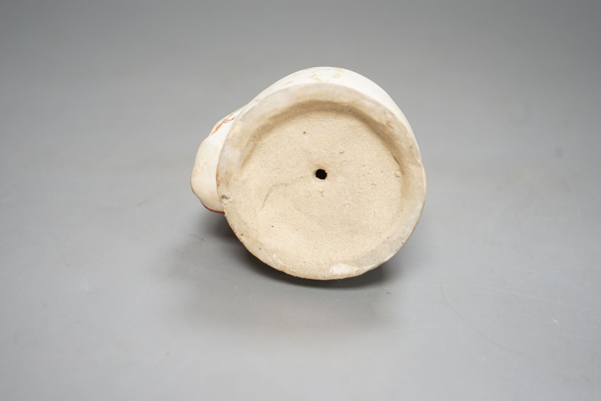 A Chinese Ming cizhou enamelled pottery group of a boy and dog, with case, 14cm